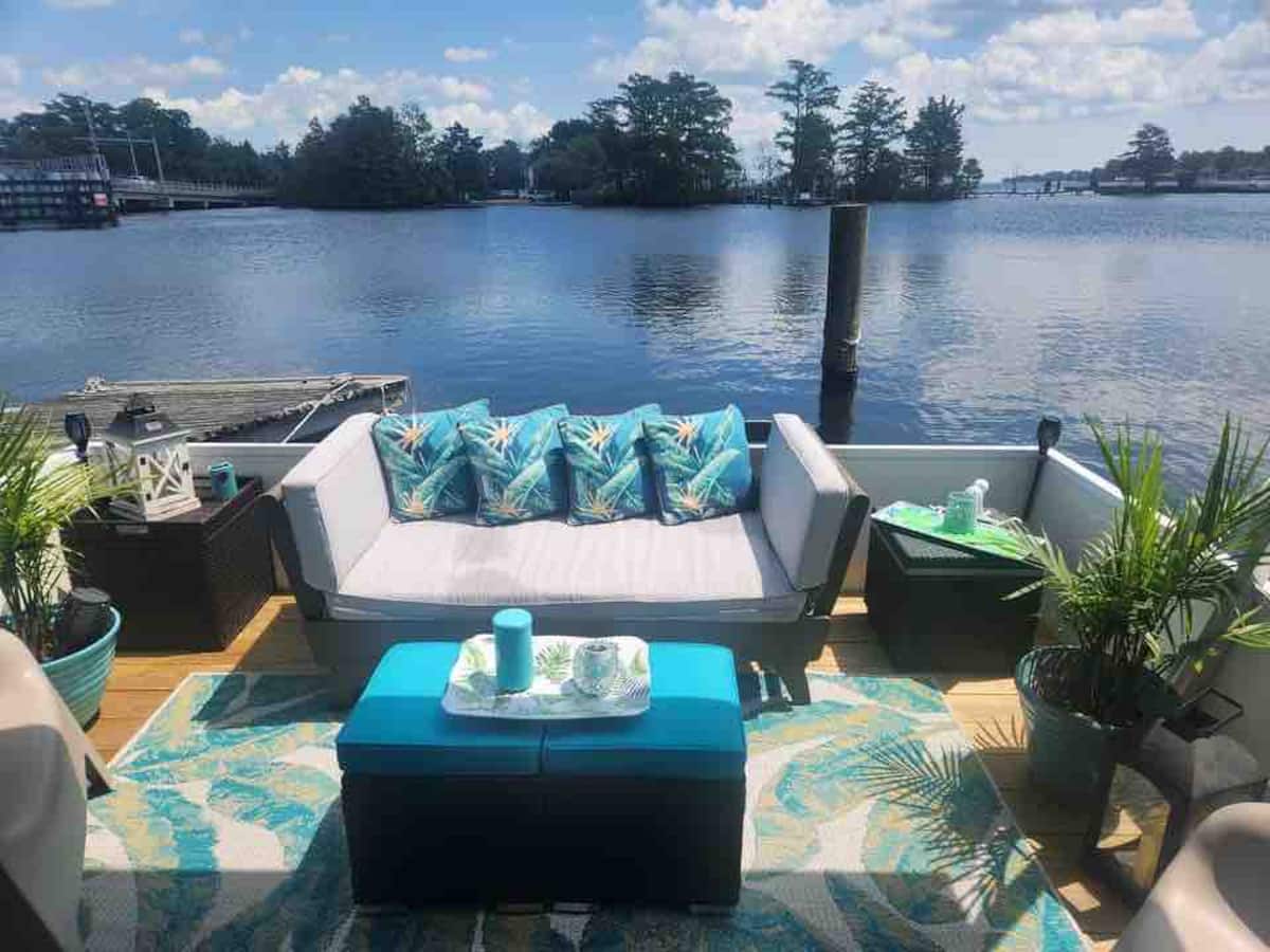 Private upper deck with turquoise seating overlooking the Pasquotank River